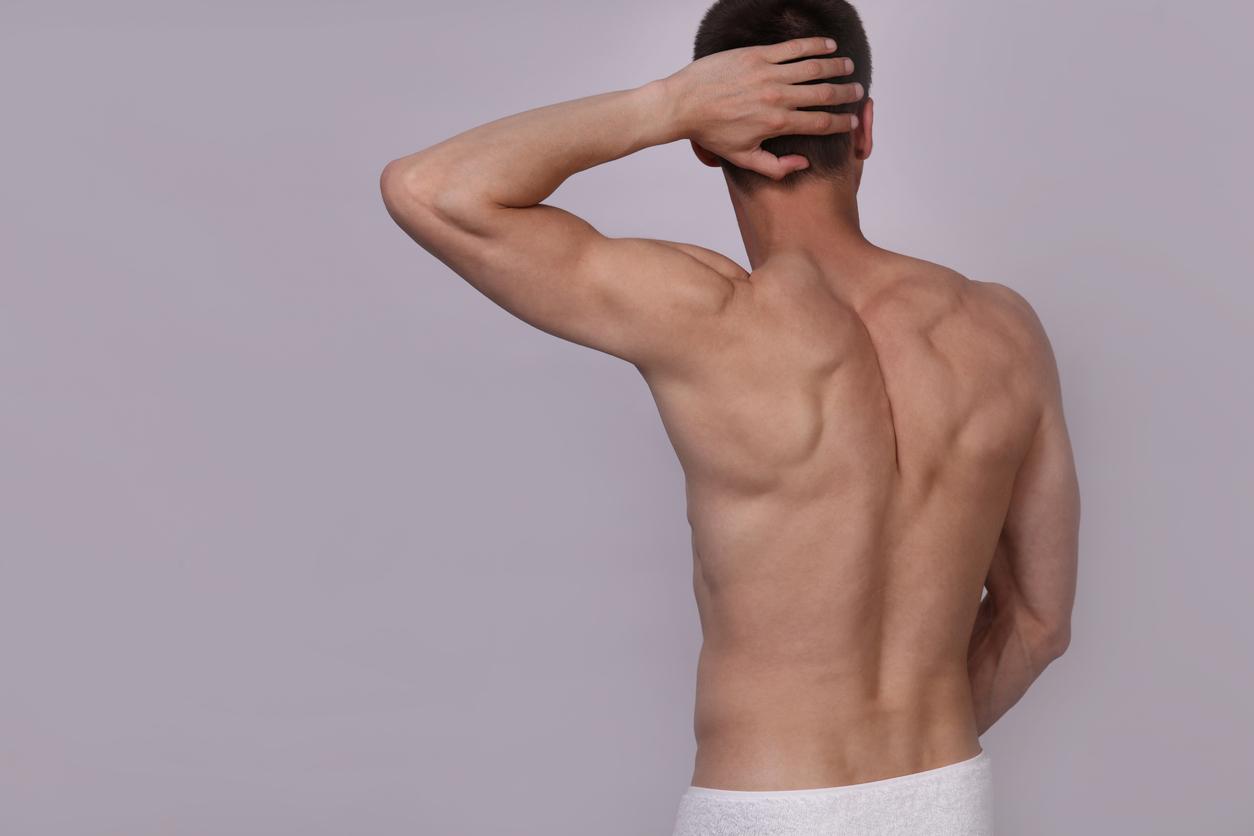Man poses to show hairless back after laser hair removal